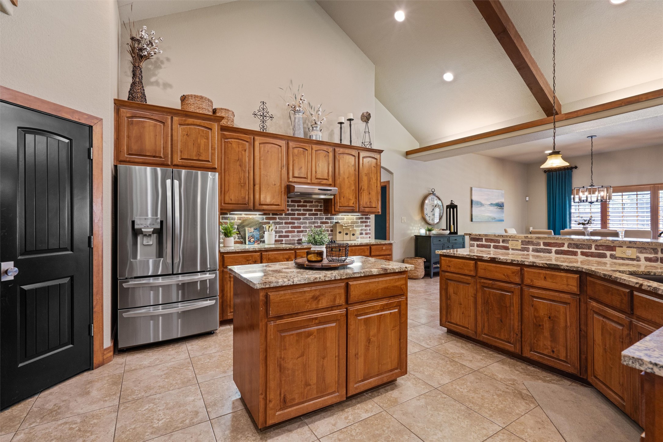 200 Little River Road Liberty Hill, TX 78642 - Photo 9 of 40 a kitchen with stainless steel appliances granite countertop a refrigerator and a stove
