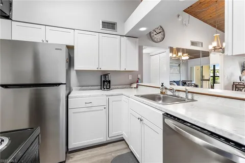 a kitchen with a sink and a refrigerator