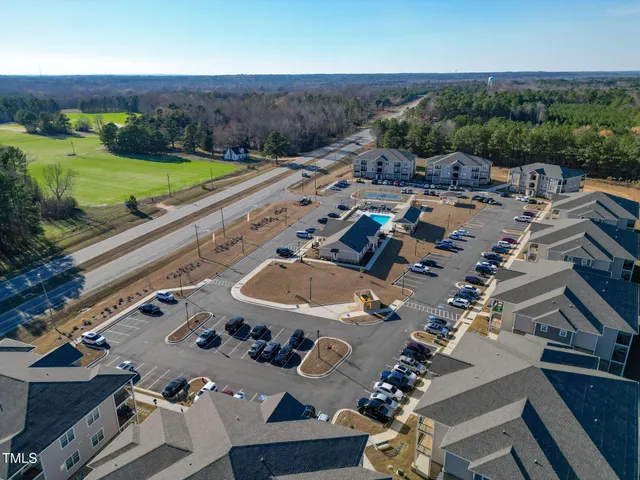 an aerial view of multiple houses with yard