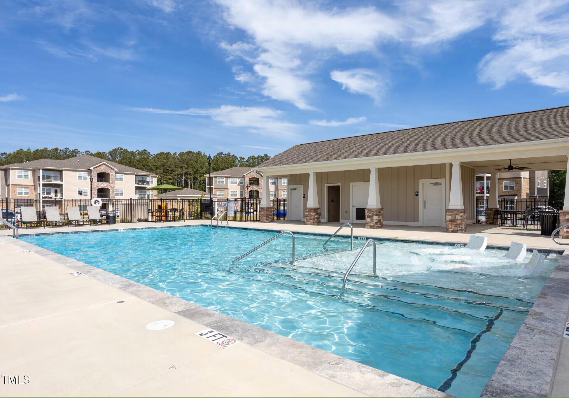 130 Grove Circle, Unit 204 Lillington, NC 27546 - Photo 20 of 28 a view of a house with swimming pool and a yard