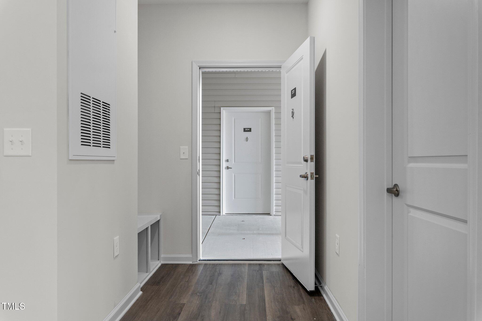 130 Grove Circle, Unit 204 Lillington, NC 27546 - Photo 5 of 28 a view of a hallway with wooden floor and closet