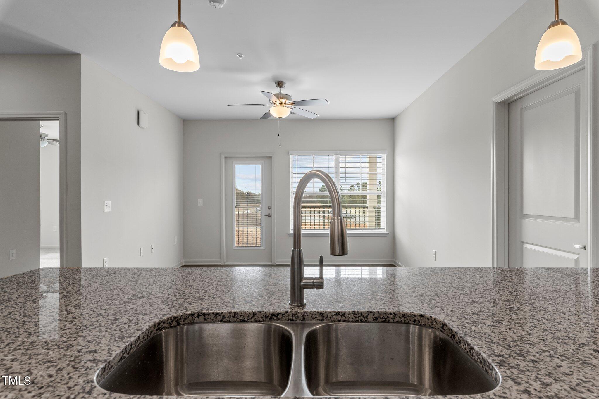 130 Grove Circle, Unit 204 Lillington, NC 27546 - Photo 10 of 28 a kitchen with granite countertop a sink and granite counter tops