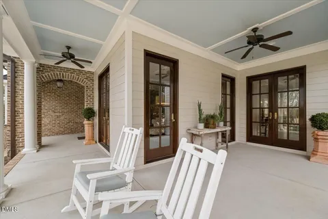 a dining room with furniture a chandelier and wooden floor