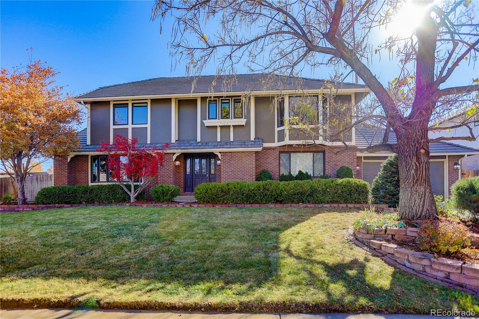 a view of house with a yard