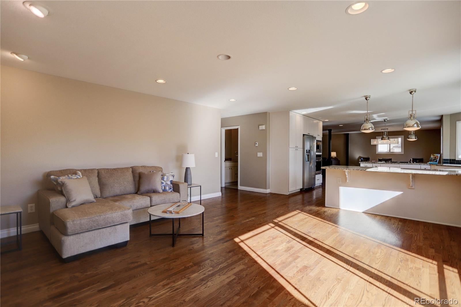 3804 Simms Street Wheat Ridge, CO 80033 - Photo 15 of 40 a living room with furniture and kitchen view