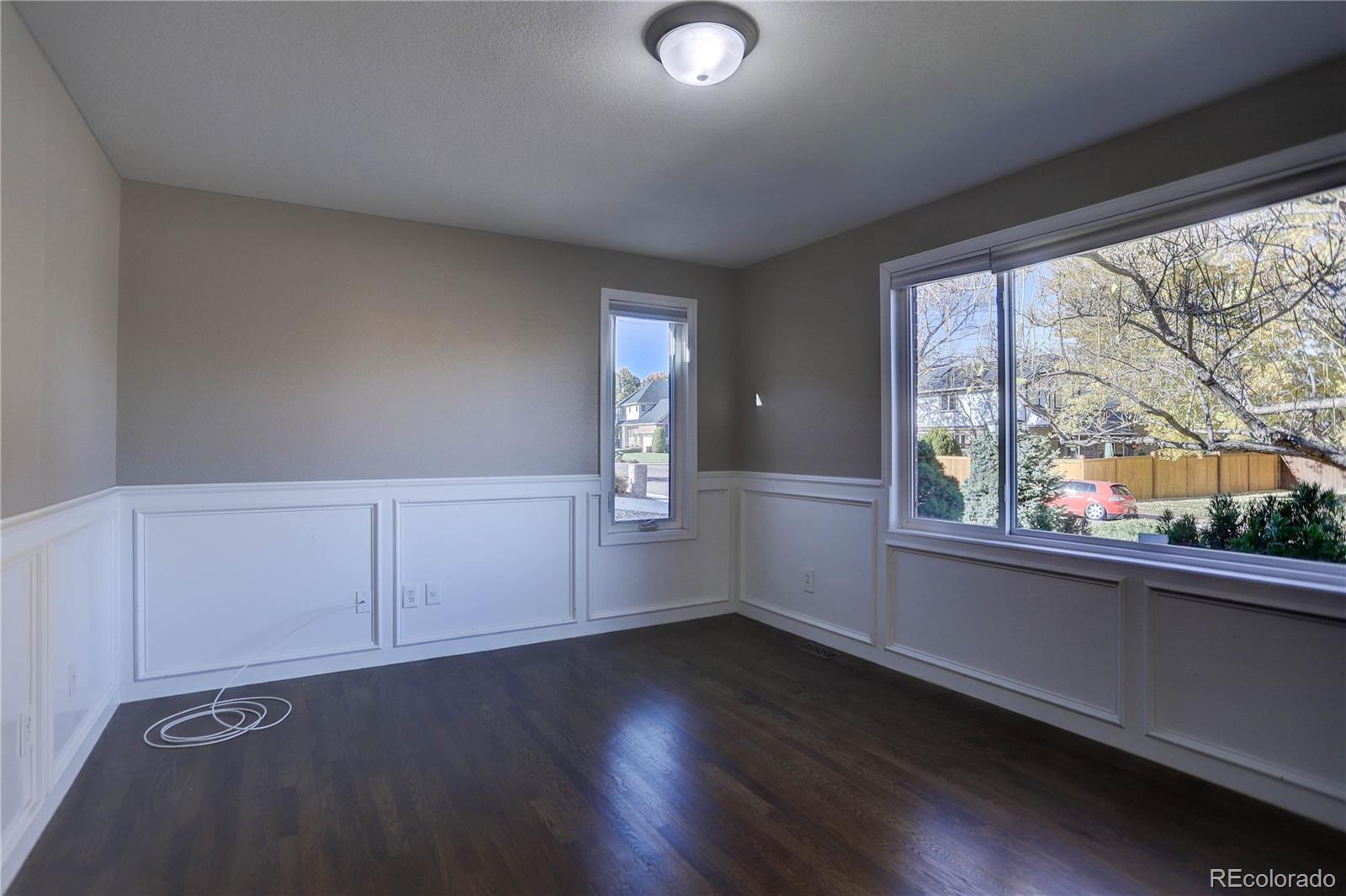 3804 Simms Street Wheat Ridge, CO 80033 - Photo 18 of 40 an empty room with wooden floor and windows