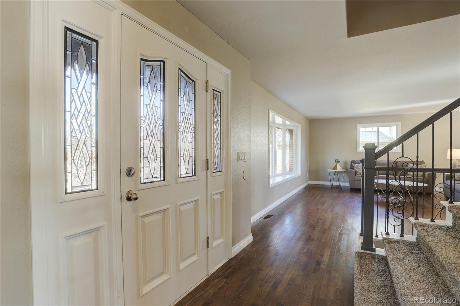 3804 Simms Street Wheat Ridge, CO 80033 - Photo 20 of 40 a view of entryway with wooden floor and stairs