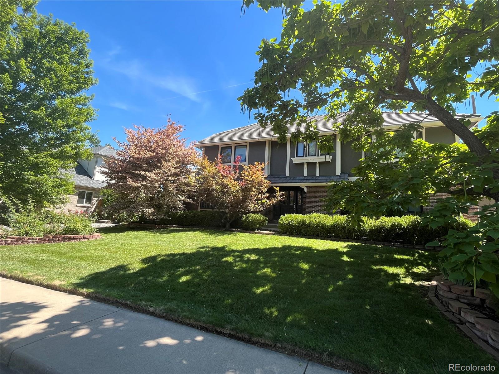 3804 Simms Street Wheat Ridge, CO 80033 - Photo 2 of 40 a view of a house with a garden