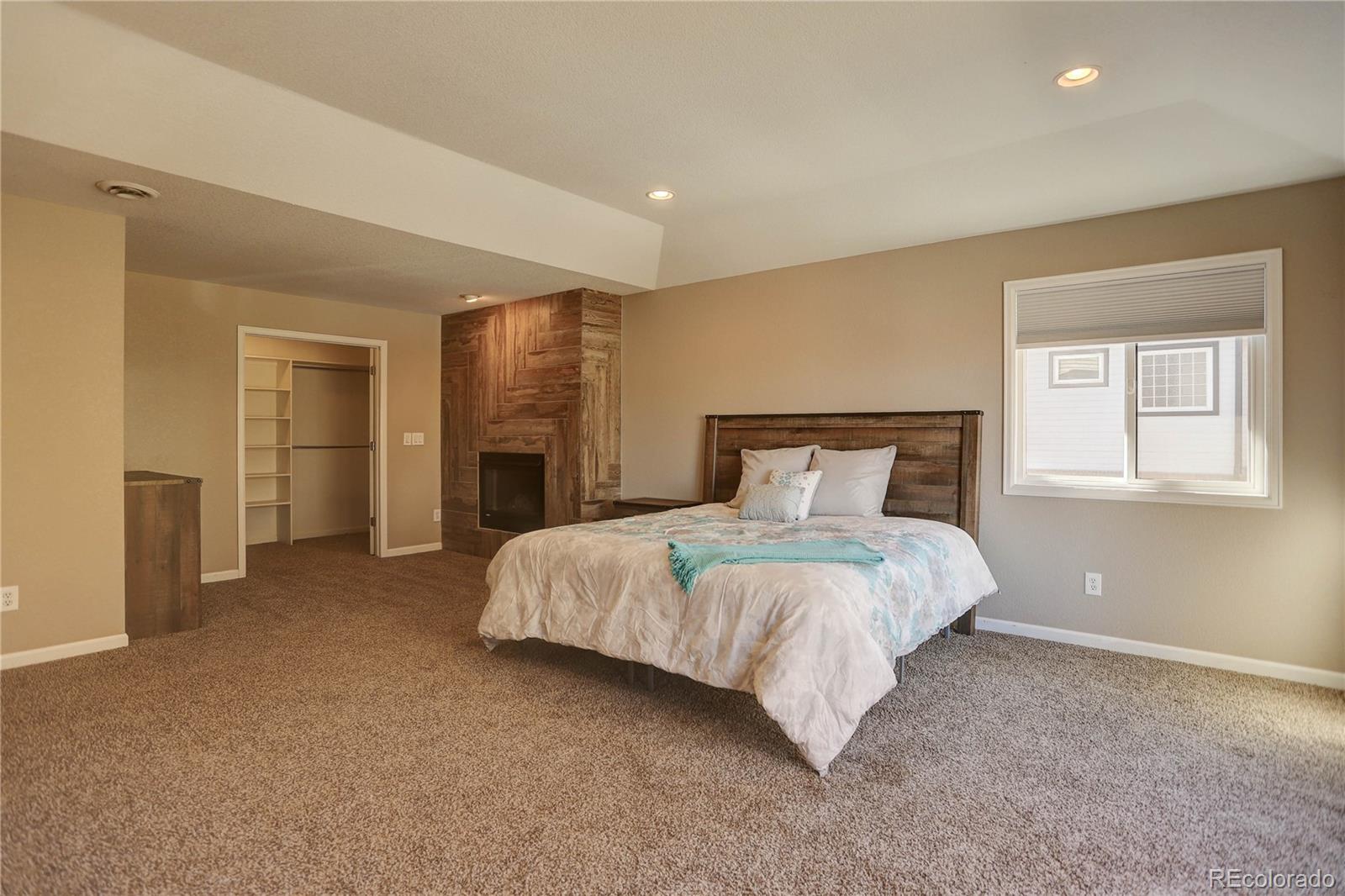 3804 Simms Street Wheat Ridge, CO 80033 - Photo 21 of 40 a bedroom with a large bed and closet