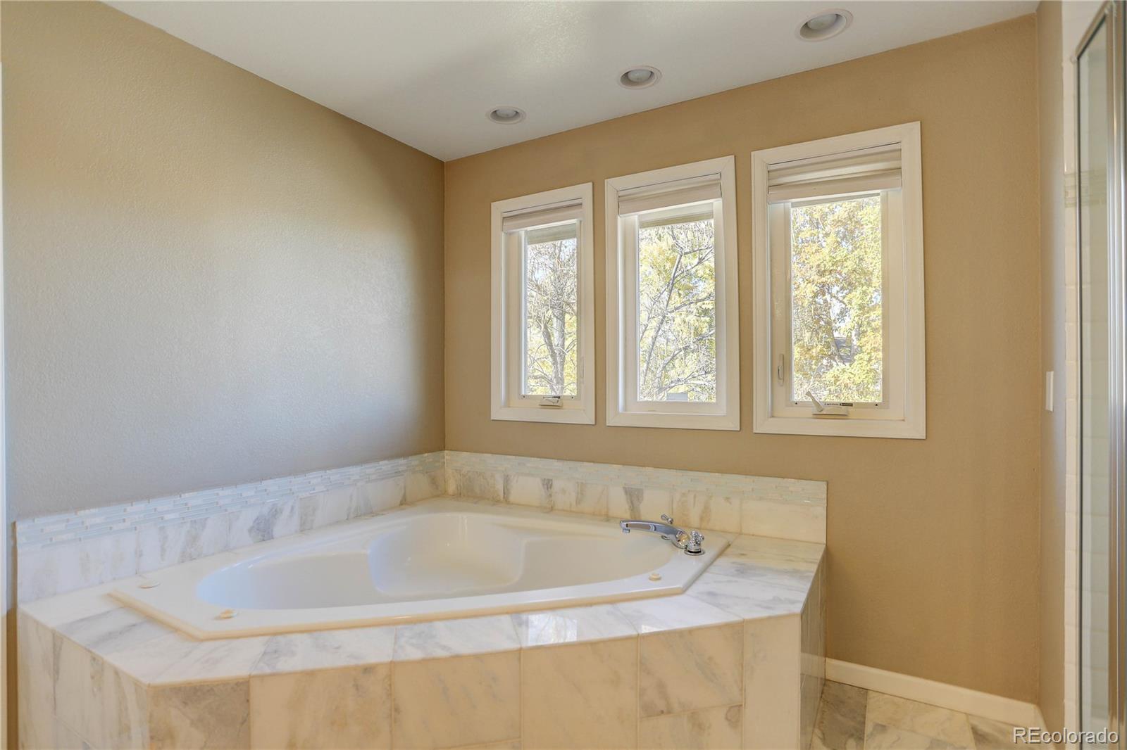 3804 Simms Street Wheat Ridge, CO 80033 - Photo 24 of 40 a bath tub sitting in a bathroom next to a window