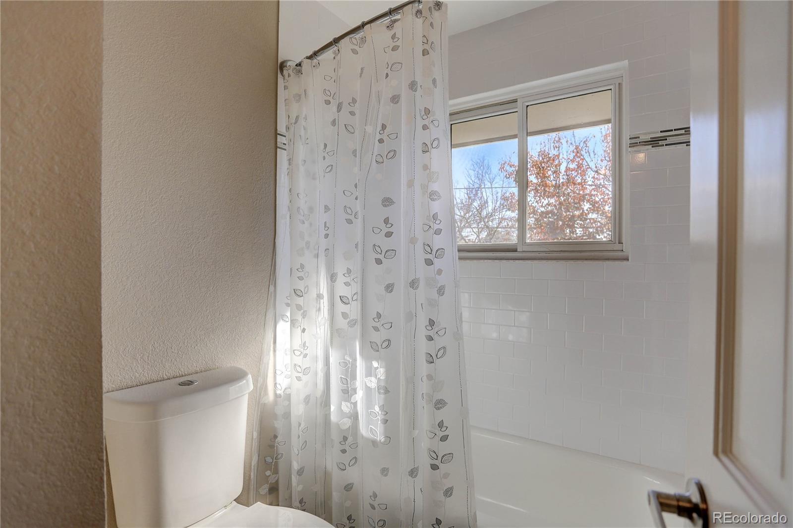 3804 Simms Street Wheat Ridge, CO 80033 - Photo 28 of 40 a bathroom with a shower and a toilet