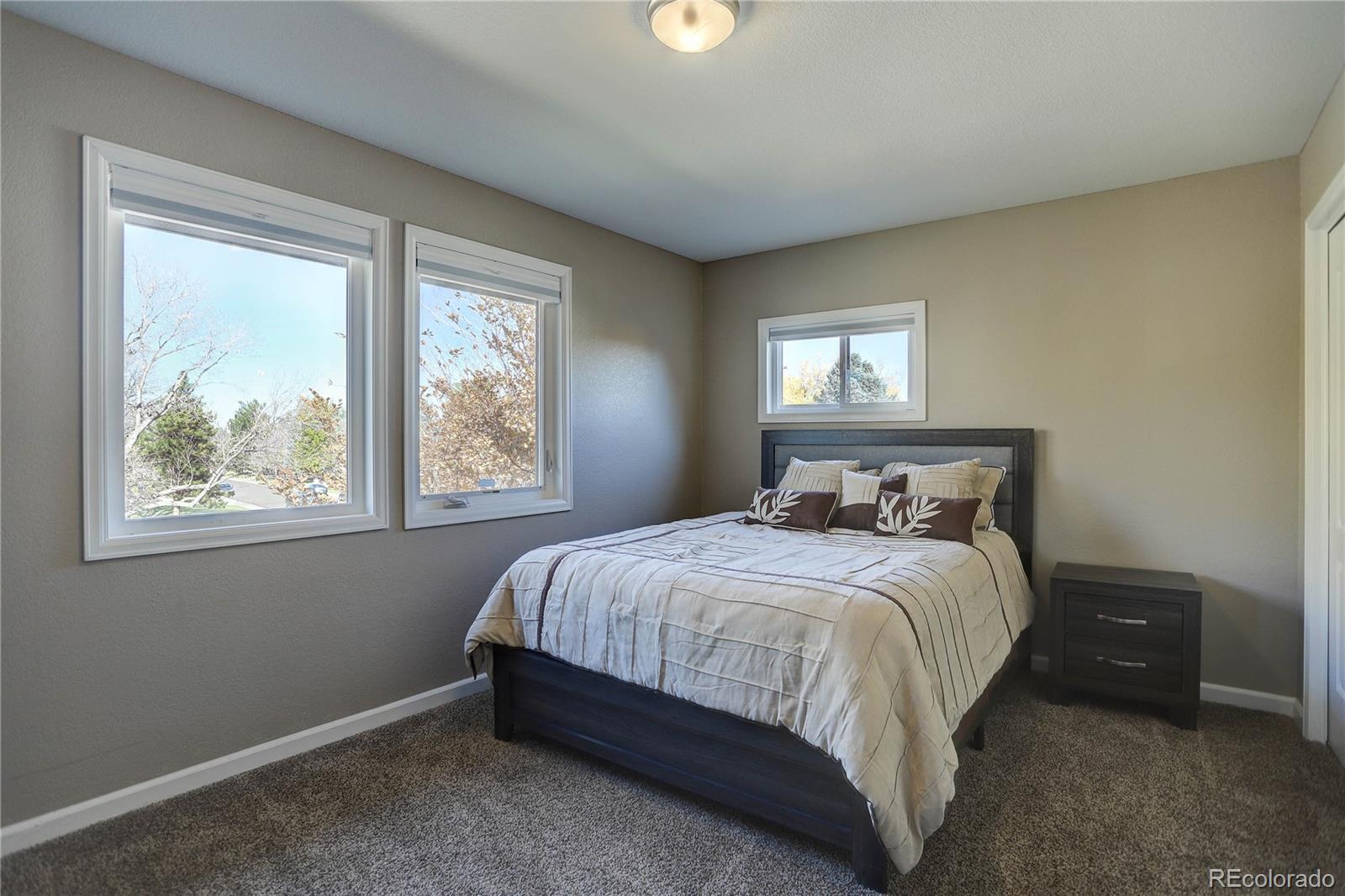 3804 Simms Street Wheat Ridge, CO 80033 - Photo 29 of 40 a bedroom with a bed and a window