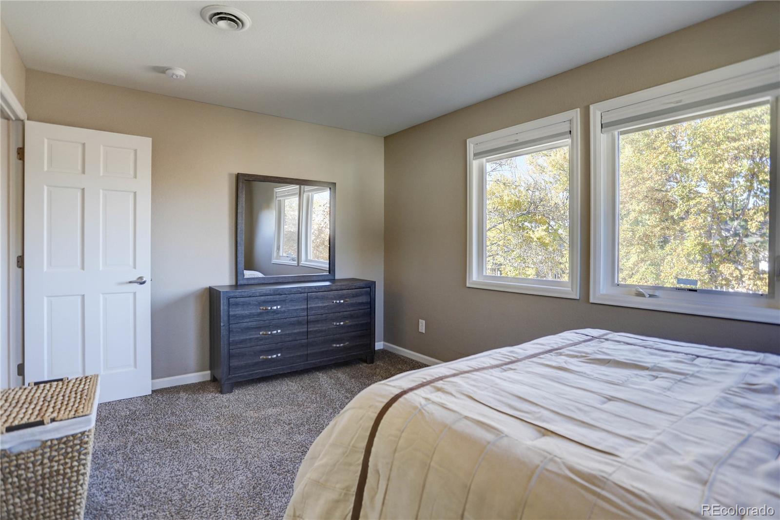 3804 Simms Street Wheat Ridge, CO 80033 - Photo 30 of 40 a bedroom with a bed and a window