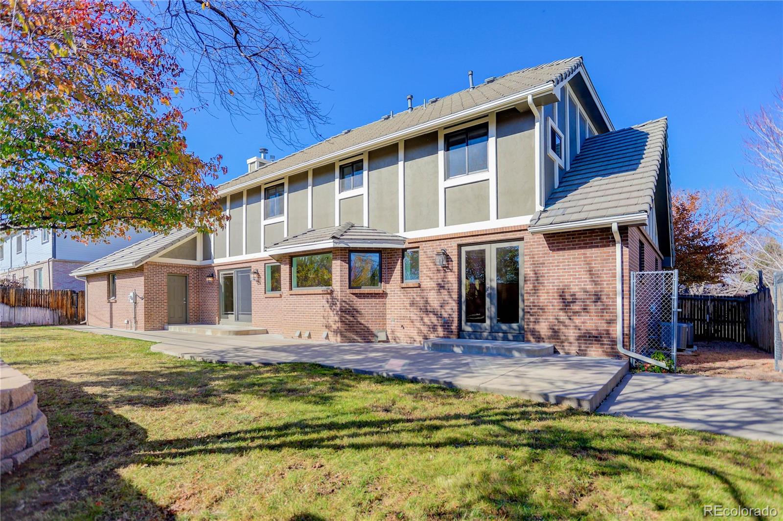 3804 Simms Street Wheat Ridge, CO 80033 - Photo 35 of 40 a front view of a house with a yard