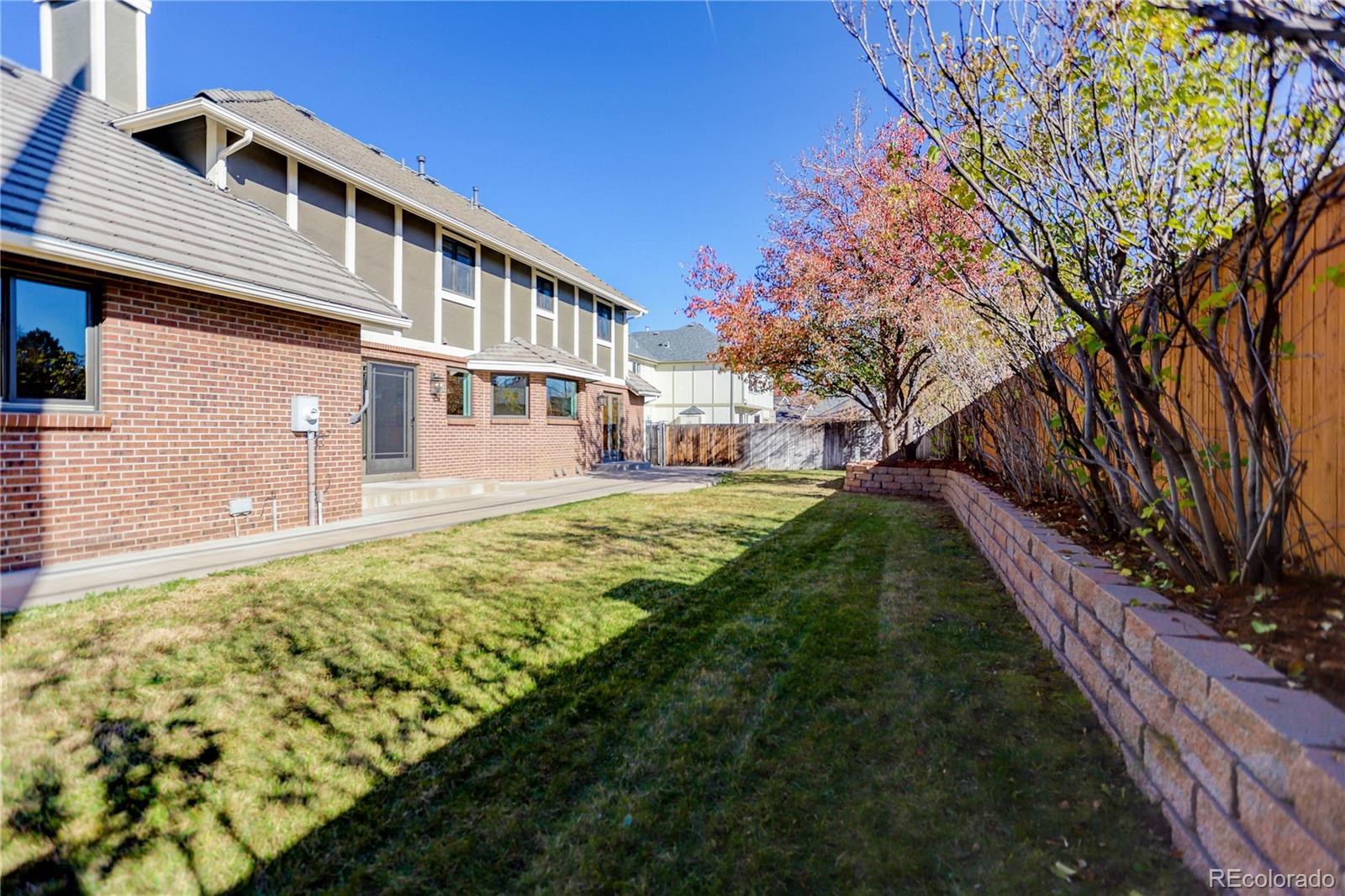 3804 Simms Street Wheat Ridge, CO 80033 - Photo 36 of 40 a front view of a house with a yard