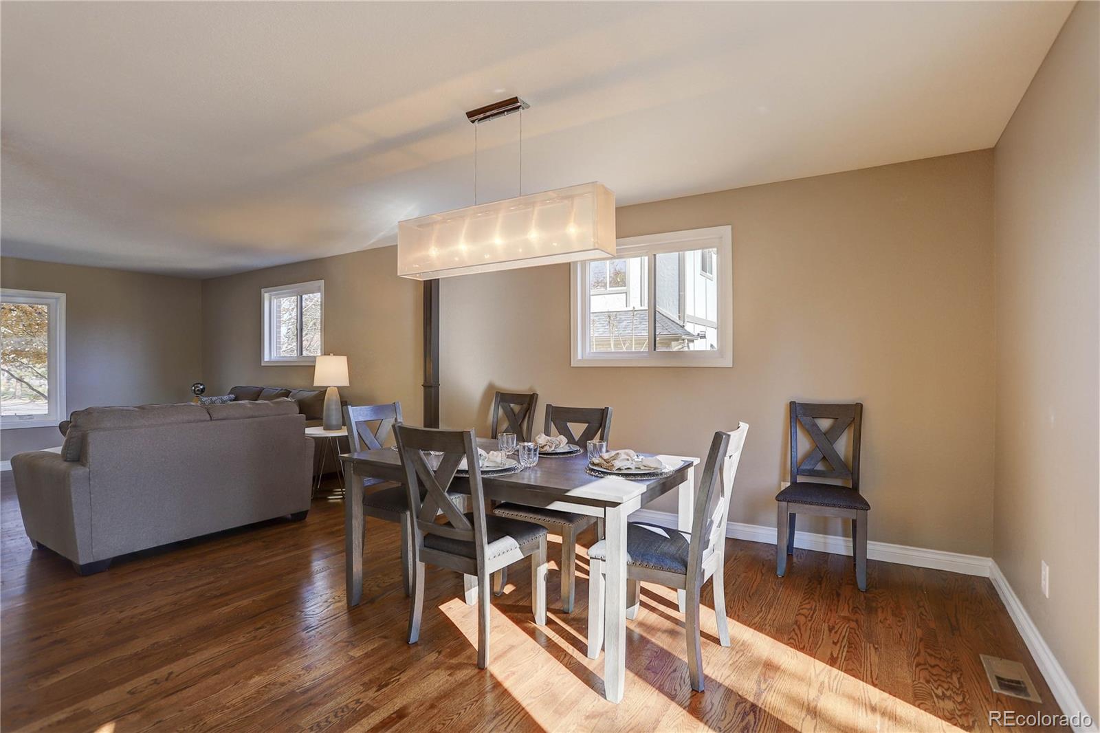 3804 Simms Street Wheat Ridge, CO 80033 - Photo 8 of 40 a view of a dining room with furniture and wooden floor