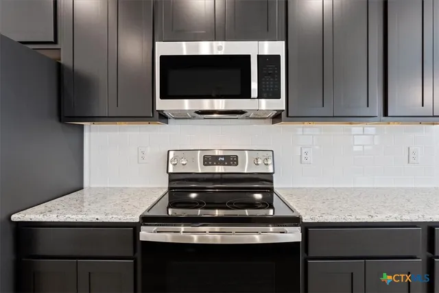 a kitchen with a stove and a microwave