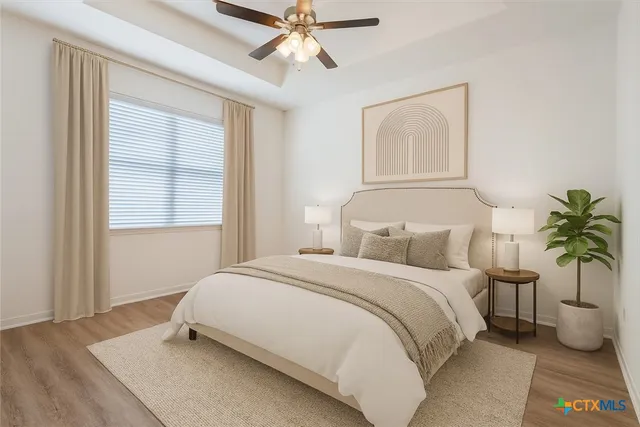 a bedroom with a large bed and a chandelier