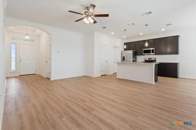 a view of a kitchen with a sink and a refrigerator