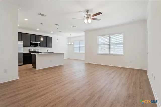 a view of kitchen with sink microwave and stove