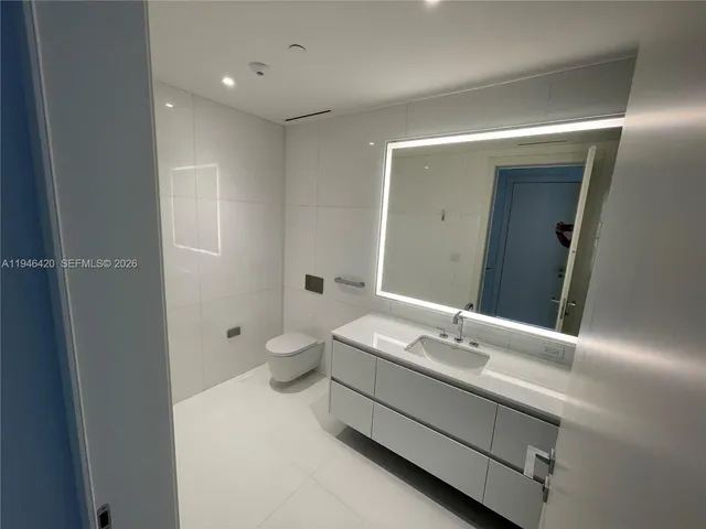 a bathroom with a sink and glass door shower