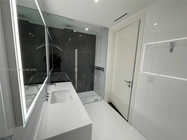 a bathroom with a glass shower door