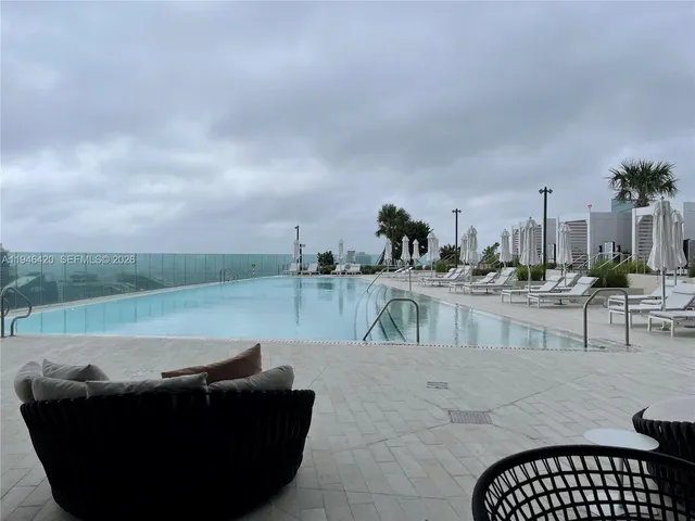 a kitchen with white cabinets and a refrigerator