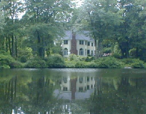 10 Long Close Road Stamford, CT 06902 - Photo 1 of 1 a view of a lake with a building in the background