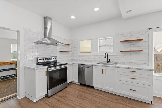 a kitchen with stainless steel appliances a sink and a stove