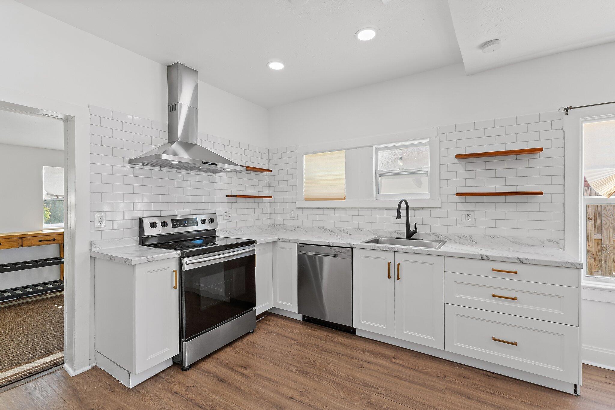 a kitchen with stainless steel appliances a sink and a stove