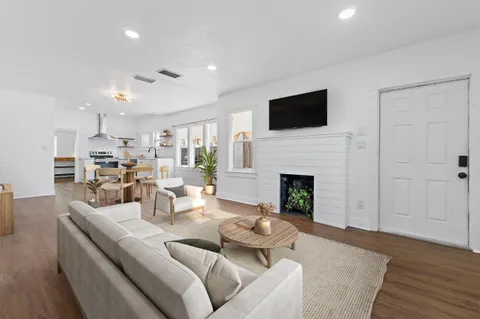 a living room with furniture fireplace and flat screen tv