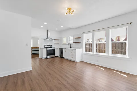 a view of kitchen with wooden floor and electronic appliances