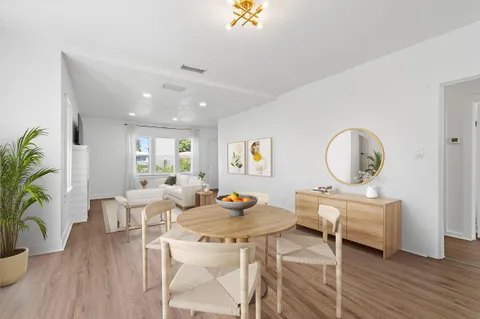 a living room with furniture a window and a potted plant