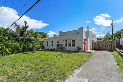 a view of a house with a yard and sitting area
