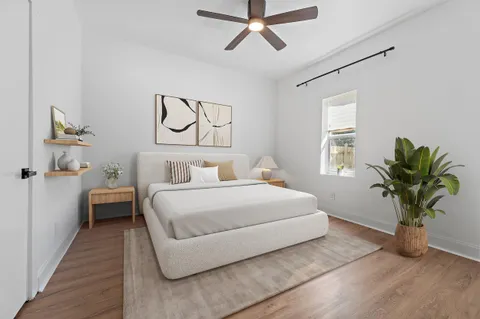 a bedroom with a bed and a potted plant