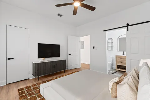 a bedroom with furniture and a flat screen tv