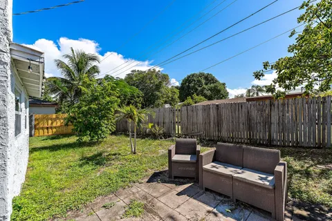 a backyard of a house with table and chairs