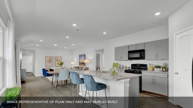 a living room with stainless steel appliances kitchen island granite countertop furniture a rug a stove and a view of kitchen