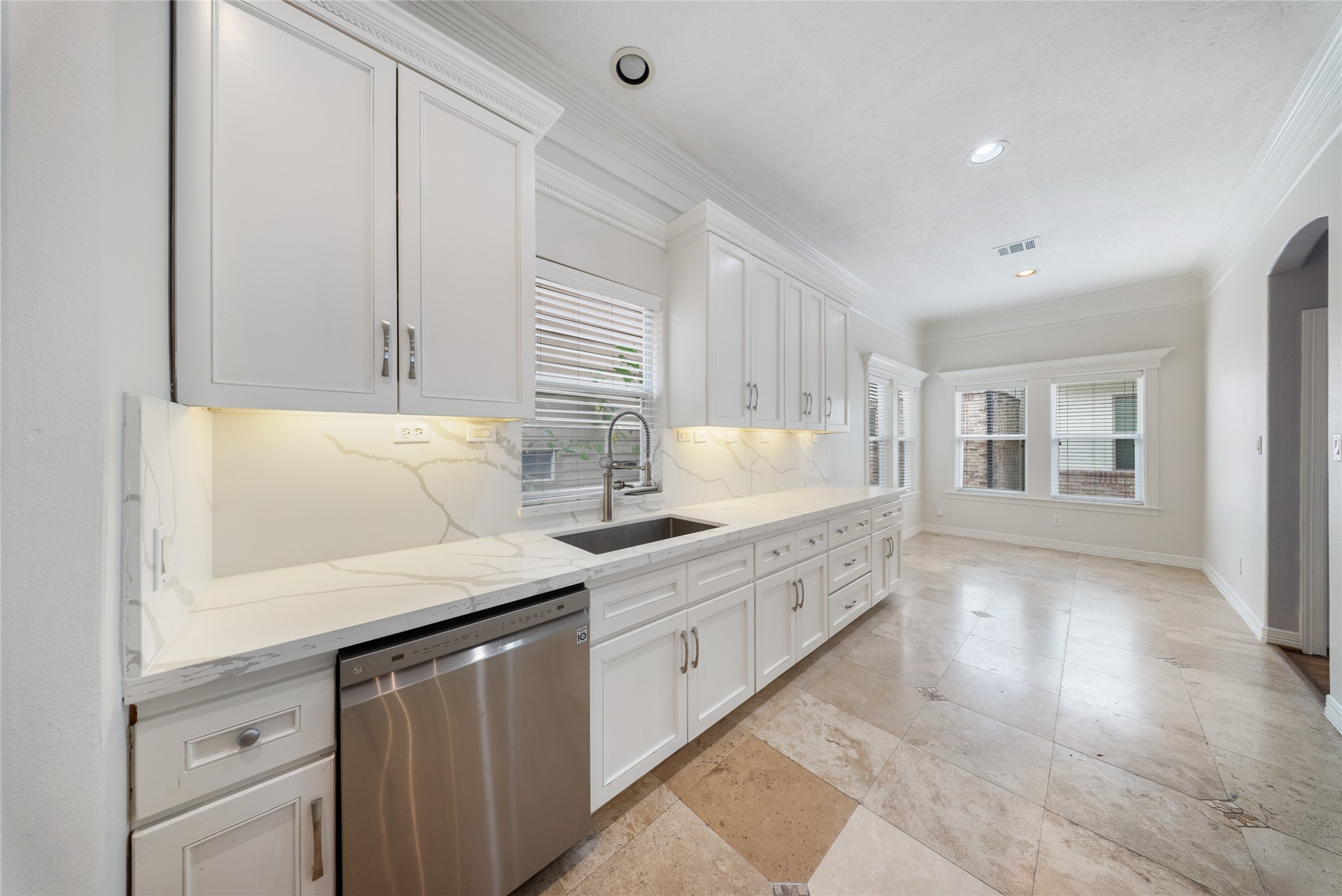 a kitchen with granite countertop white cabinets and white appliances