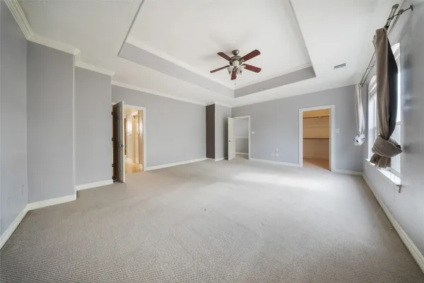 a view of a livingroom with a ceiling fan and window