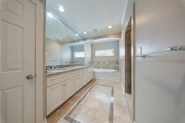 a bathroom with a granite countertop sink mirror and shower