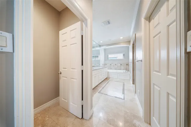 a bathroom with a glass shower door and a mirror