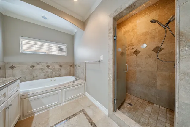 a bathroom with a tub a sink and shower