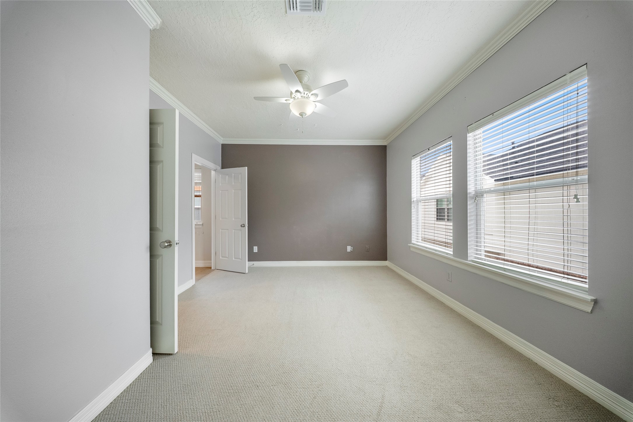 4216 Eli Street Houston, TX 77007 - Photo 17 of 25 an empty room with chandelier fan and windows