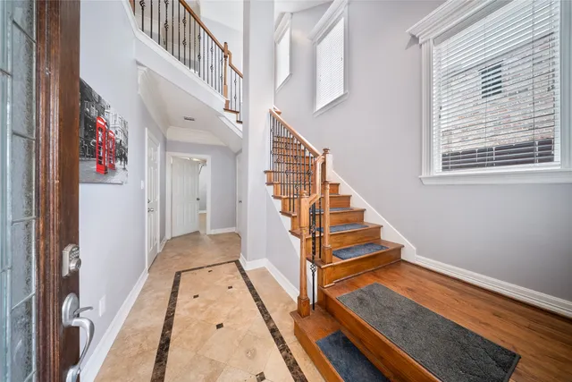 a view of staircase with white walls and a window