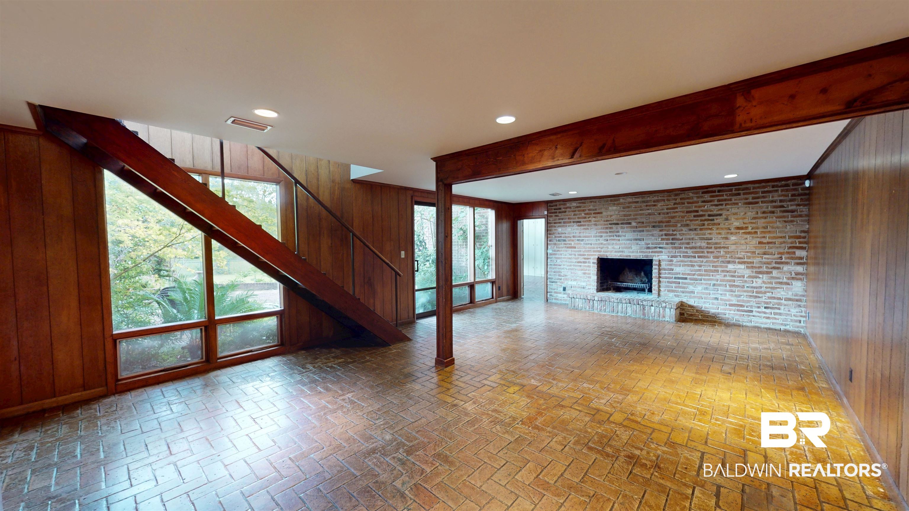 15 Spring Bank Road Mobile, AL 36608 - Photo 20 of 58 Unfurnished room with wooden walls, brick flooring, beam ceiling, a brick fireplace, and recessed lighting