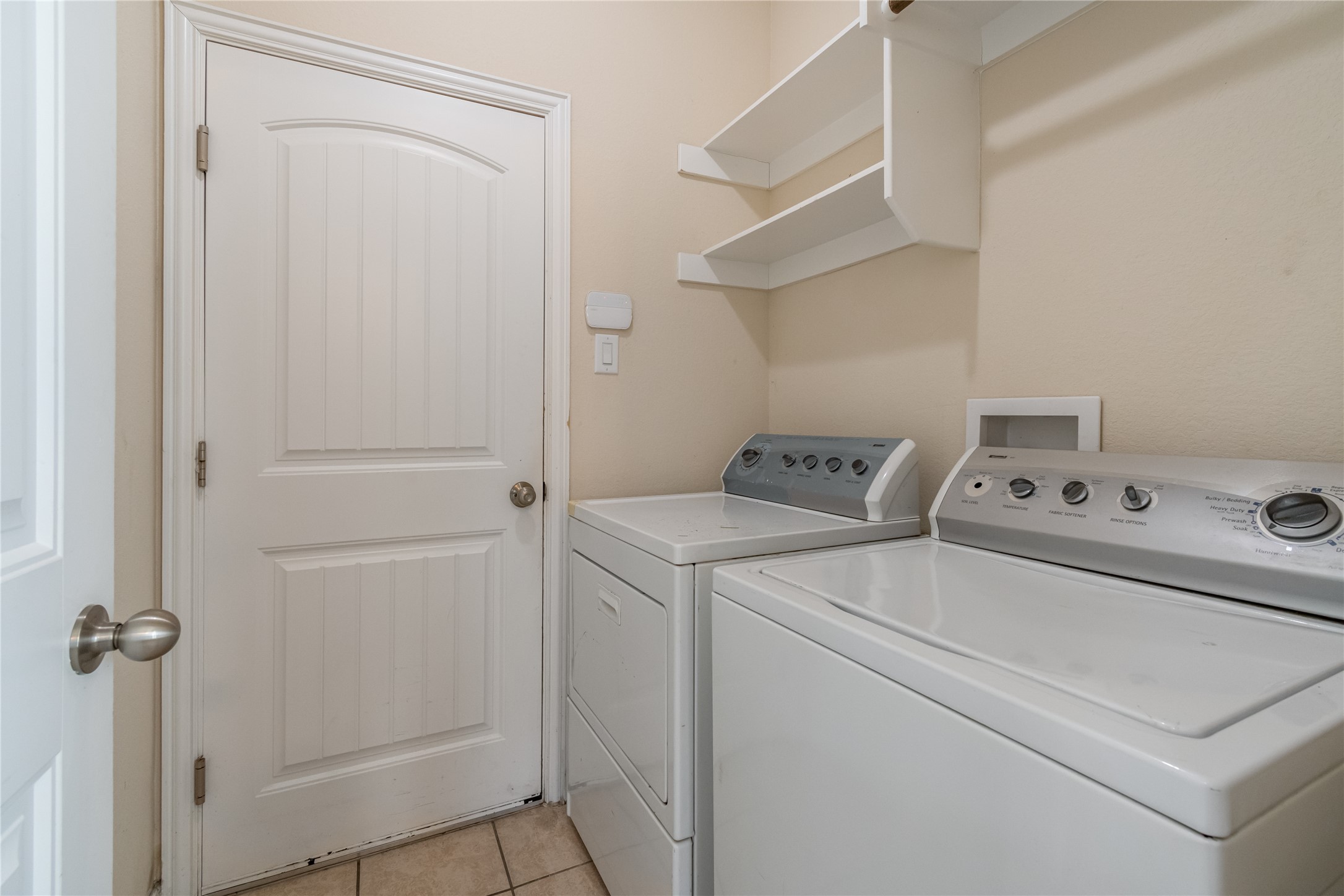 3413 Grail Hollows Road Pflugerville, TX 78660 - Photo 11 of 36 Laundry room featuring light tile patterned floors and separate washer and dryer