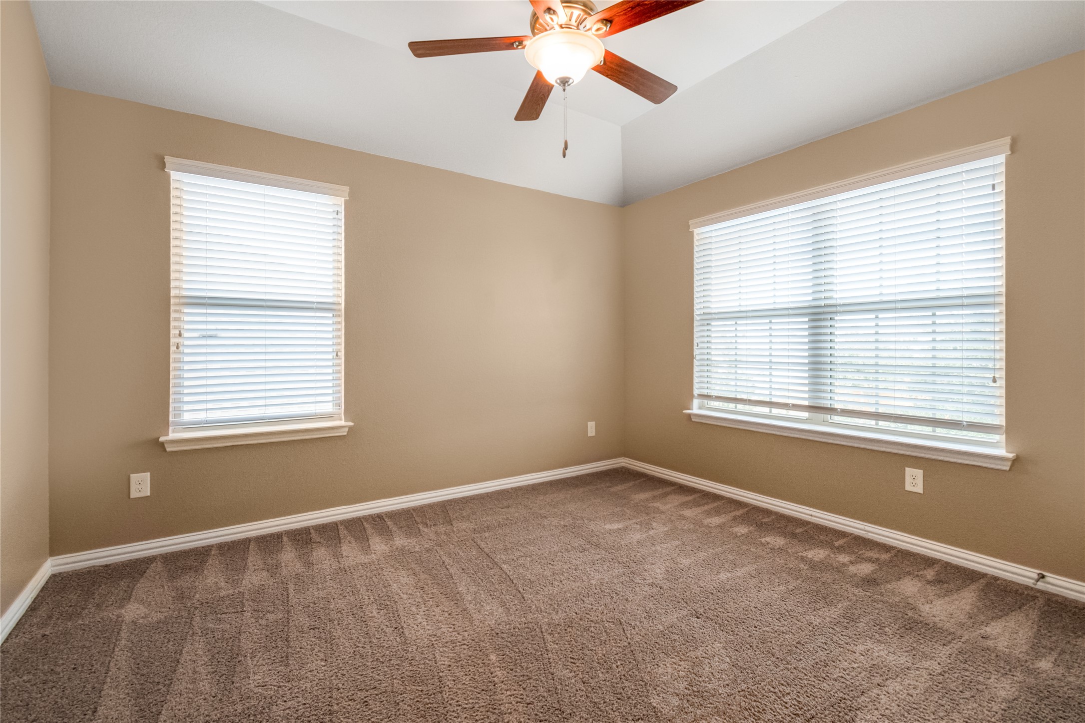 3413 Grail Hollows Road Pflugerville, TX 78660 - Photo 26 of 36 Carpeted spare room featuring a ceiling fan, healthy amount of natural light, and vaulted ceiling