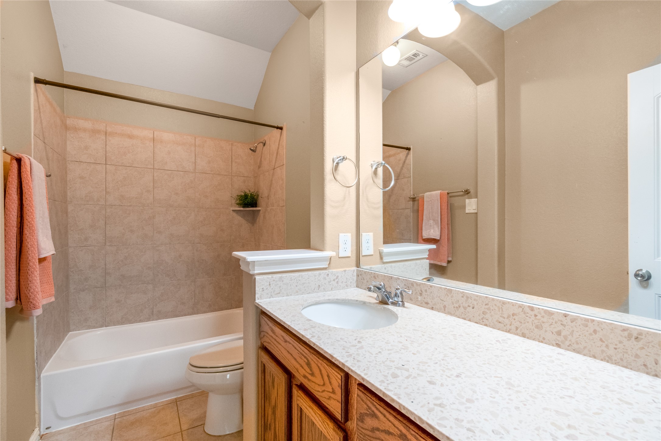 3413 Grail Hollows Road Pflugerville, TX 78660 - Photo 28 of 36 Full bathroom with vanity, bathtub / shower combination, light tile patterned floors, and lofted ceiling