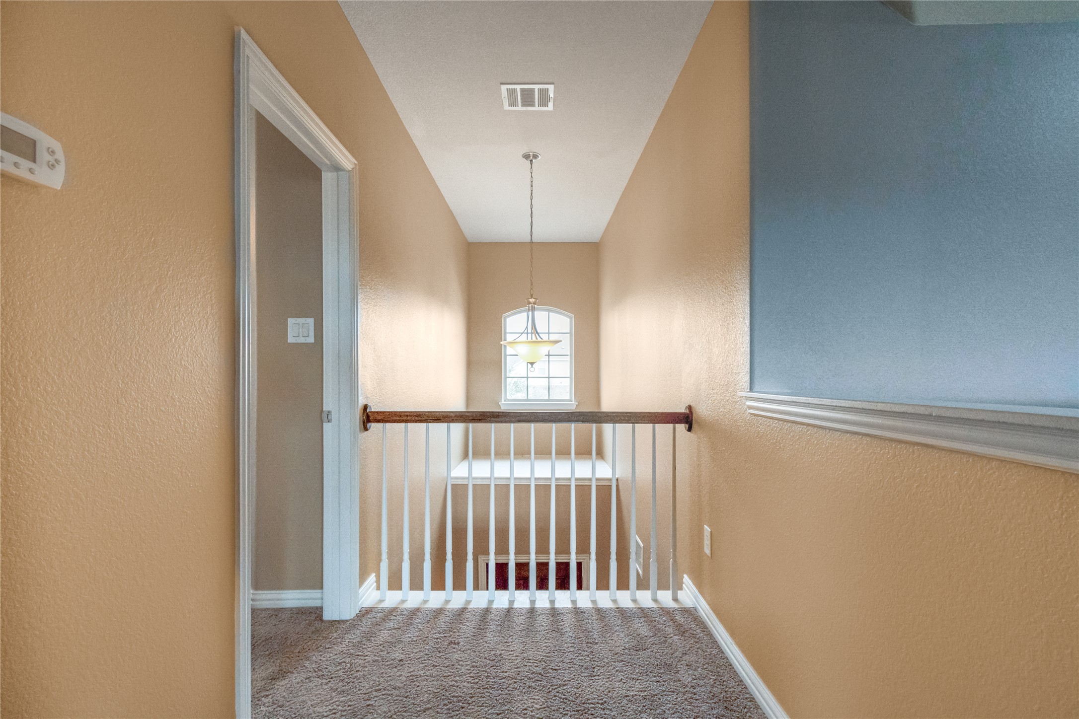 3413 Grail Hollows Road Pflugerville, TX 78660 - Photo 30 of 36 Hallway featuring a textured wall and carpet flooring